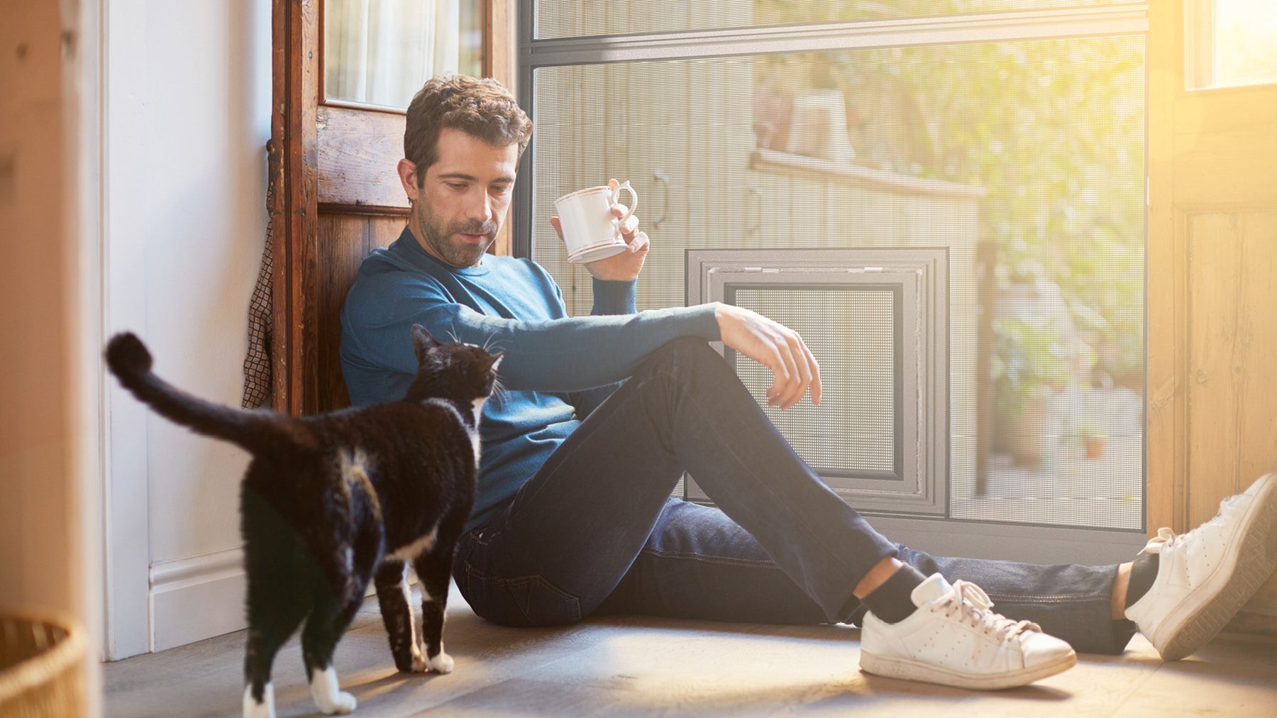 Mann Katze vor Teba Haustierklappe