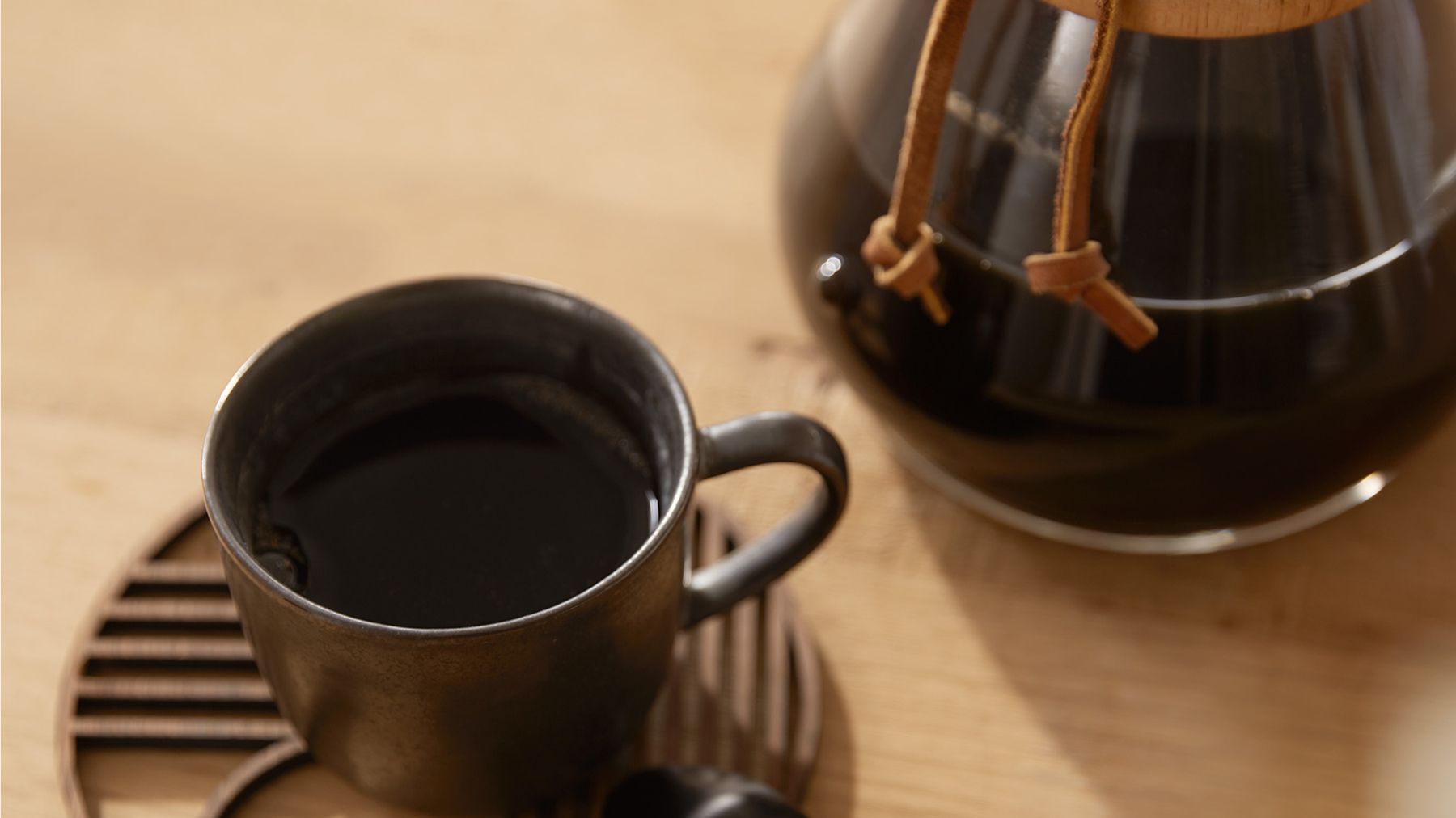 Tasse auf Teller mit Kaffeekanne